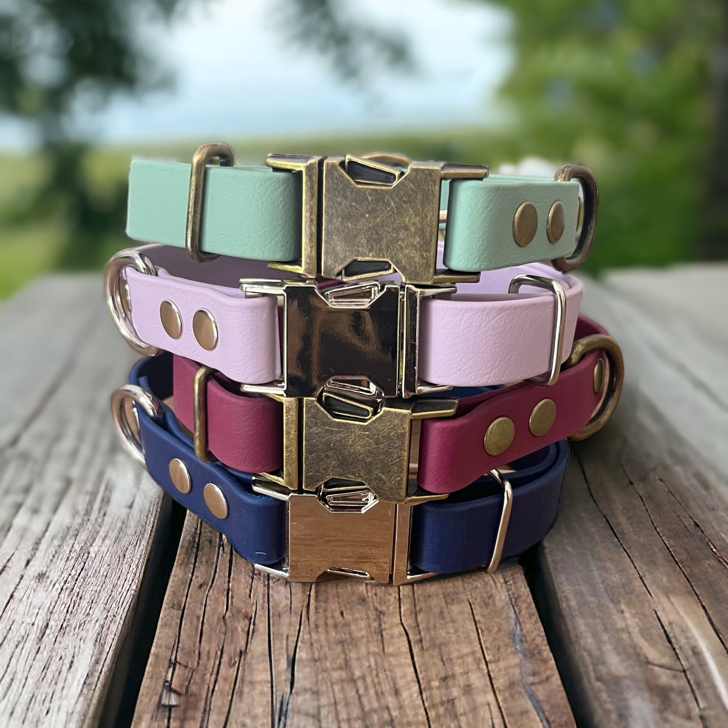 a collection of biothane quick release dog collars with metal quick release buckles, a d-ring and fastened with rivets.