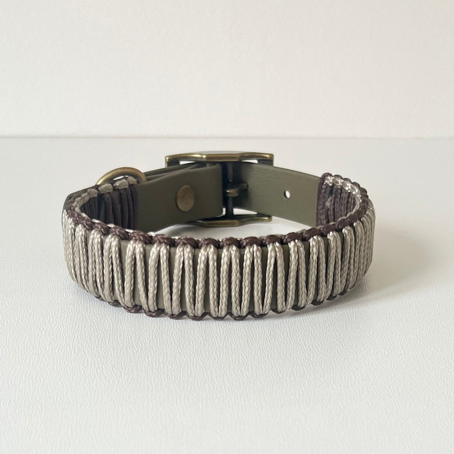 Olive strap dog collar with brown and tan cord wrapping with antique brass hardware