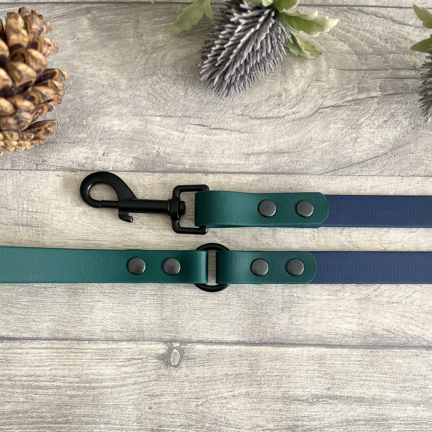 Two coloured Biothane dog lead. The handle and accent colour at the clip end of the lead is Dark Green, the mail lead colour is Navy giving the lead a two tone look. The hardware is Black