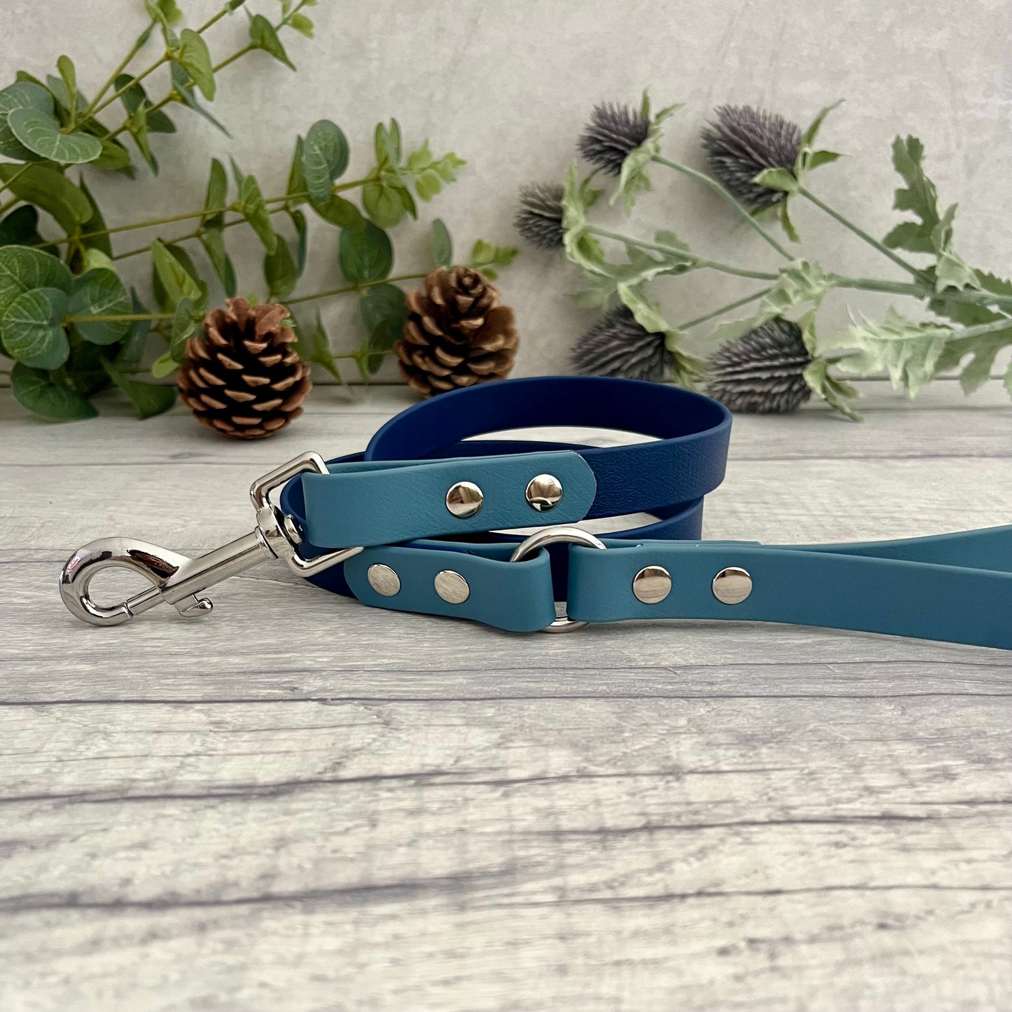 Two coloured Biothane dog lead. The handle and accent colour at the clip end of the lead is Petrol Blue, the mail lead colour is Navy giving the lead a two tone look. The hardware is Silver.