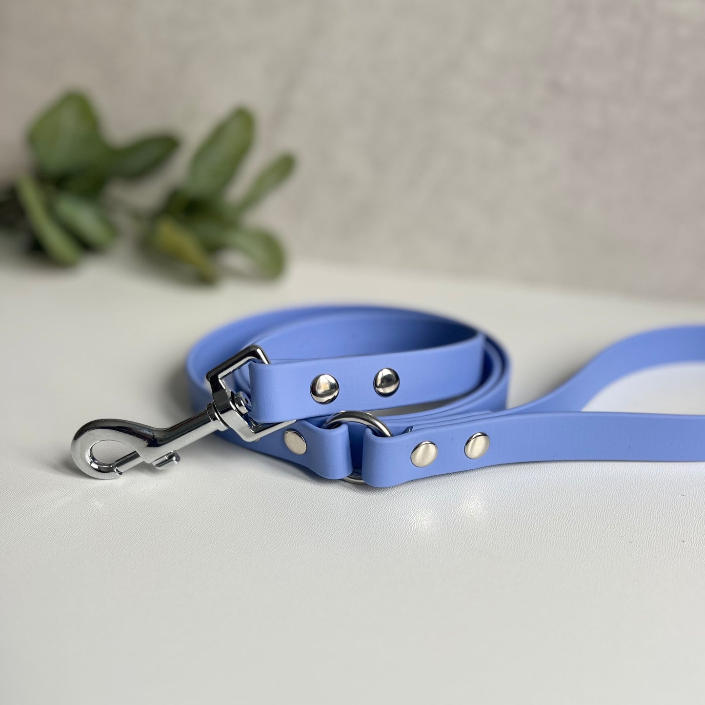 Periwinkle Biothane lead with Silver hardware. An O-ring connects the handle to the lead with double ended rivets fixing it together. A Snap Clip is fixed with double ended rivets. The lead has a soft leather appearance.