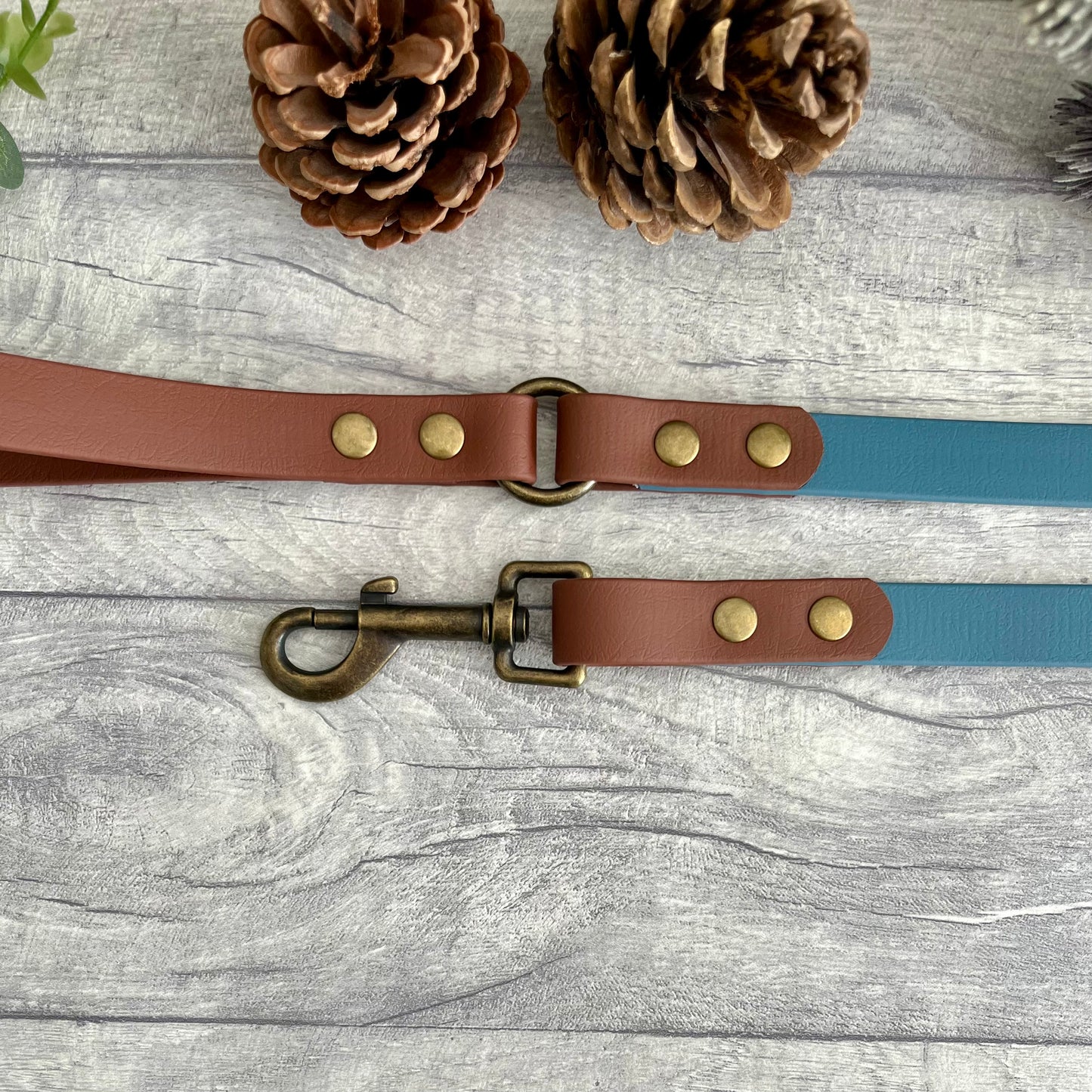 Two coloured Biothane dog lead. The handle and accent colour at the clip end of the lead is Brown, the mail lead colour is Petrol Blue giving the lead a two tone look. The hardware is Antique Brass