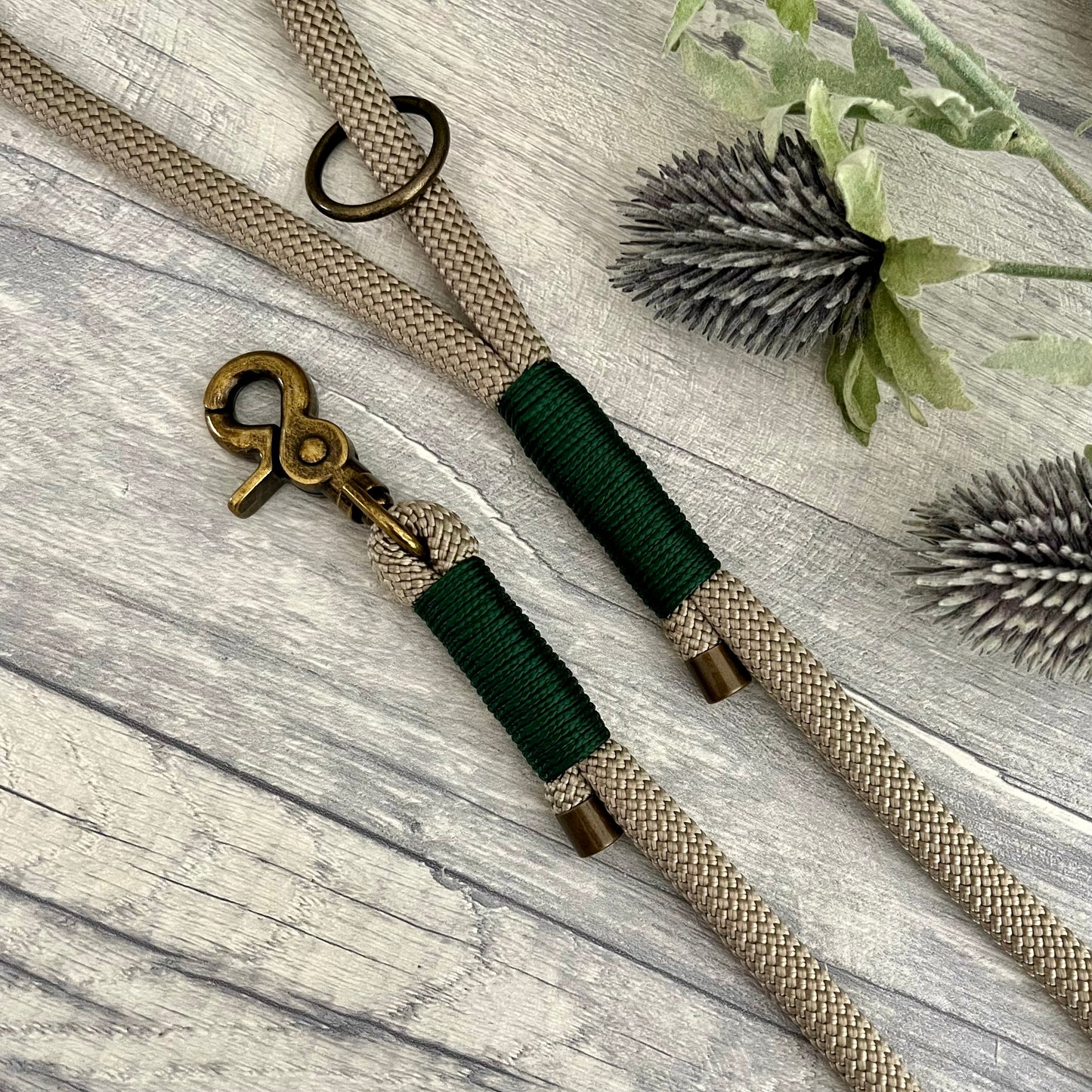 Tan rope dog lead with Dark Green whipping securing a swivel clip at one end with whipping securing a handle at the other. The ends of the rope ends are finished with metal end caps. All hardware is in Antique Brass