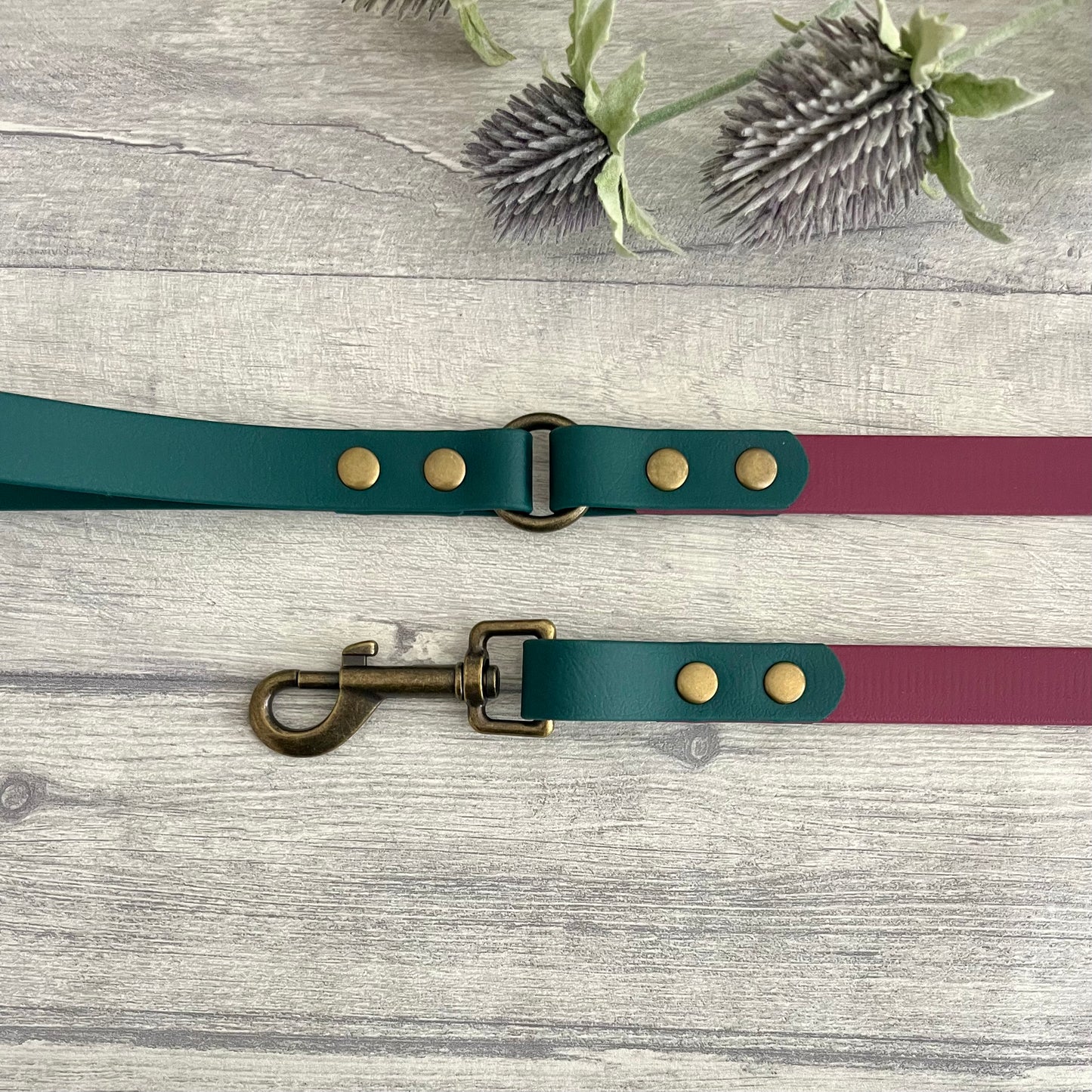 Two coloured Biothane dog lead. The handle and accent colour at the clip end of the lead is Dark Green, the mail lead colour is Wine Red giving the lead a two tone look. The hardware is Antique Brass