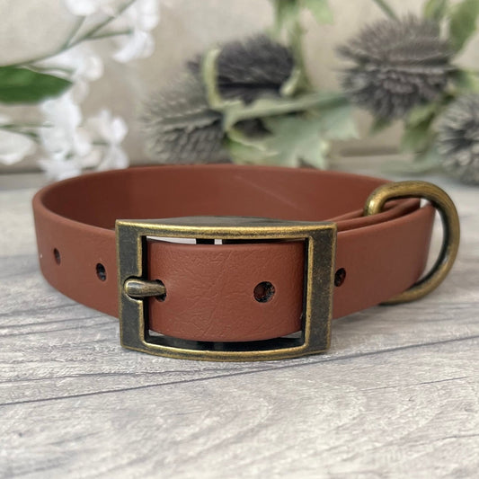 Biothane custom collar in Brown with Antique Brass buckle and a D-ring. The collar has 5 holes which are spaced 2cm apart. The collar is fastened on the first hole and has a soft leather appearance