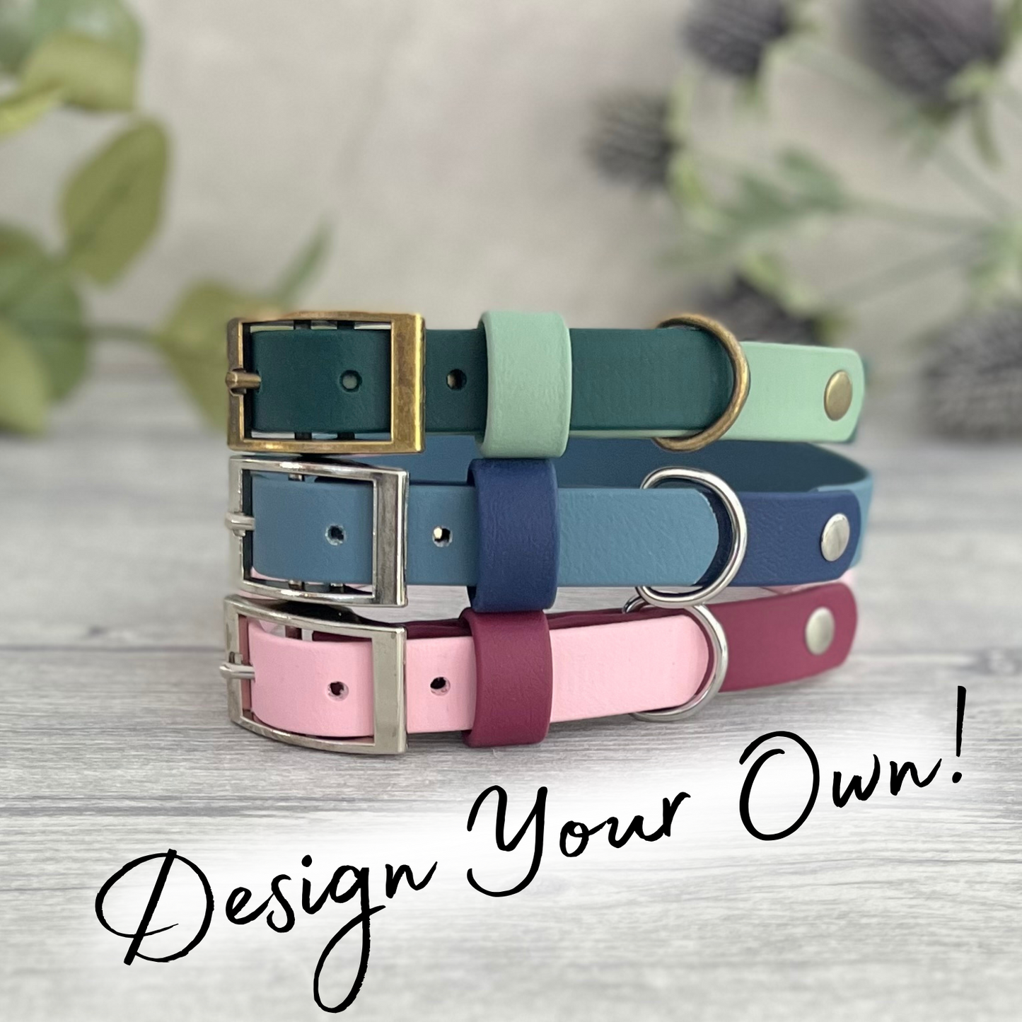 Three colorful dog collars stacked on a wooden surface with a blurred natural background.