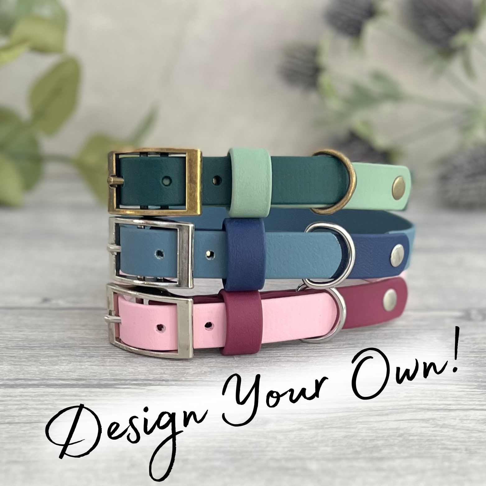 Three colorful dog collars stacked on a wooden surface with a blurred natural background.