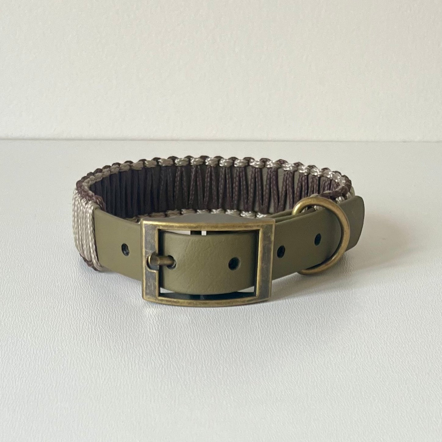 Olive strap dog collar with brown and tan cord wrapping with antique brass hardware