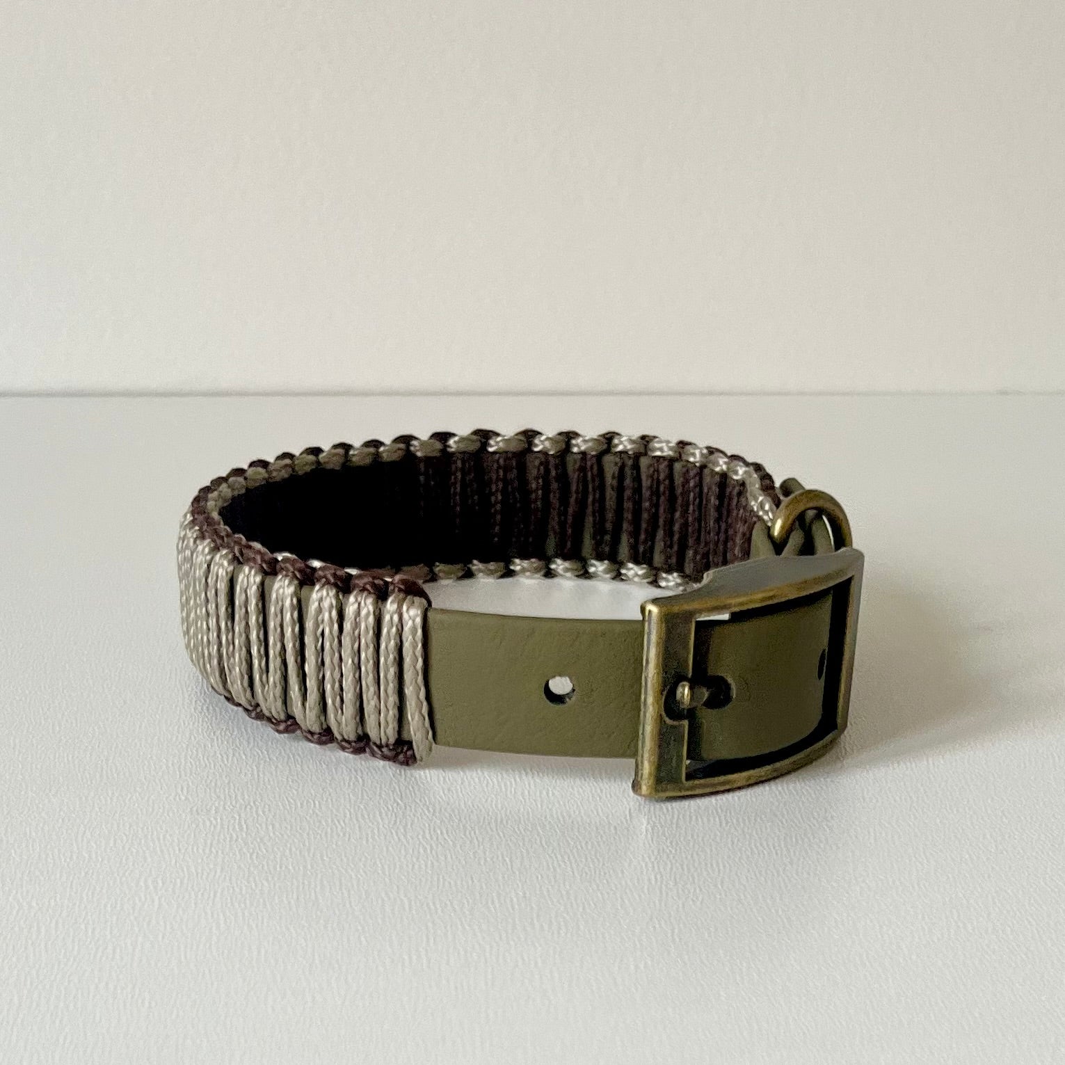 Olive strap dog collar with brown and tan cord wrapping with antique brass hardware