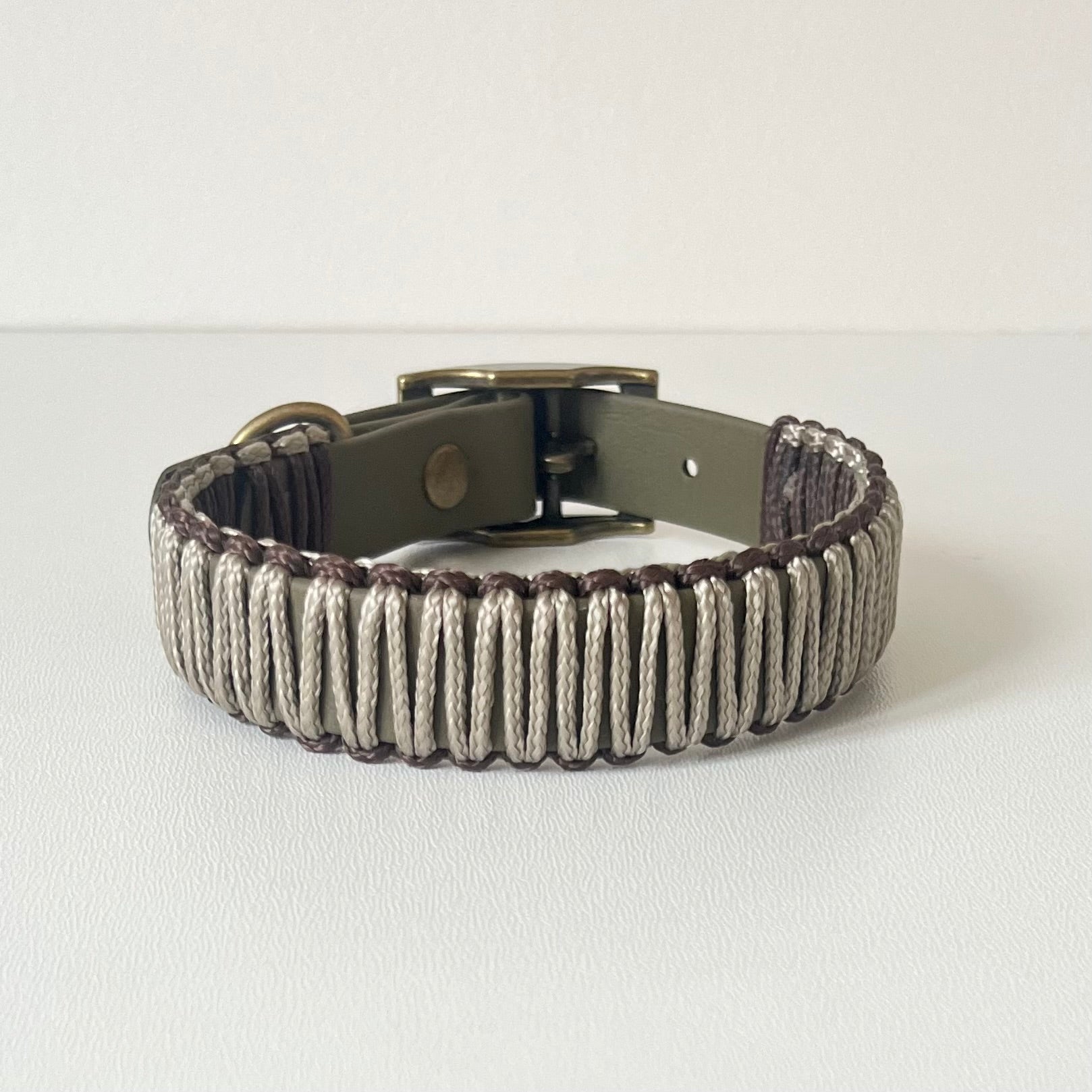 Olive strap dog collar with brown and tan cord wrapping with antique brass hardware