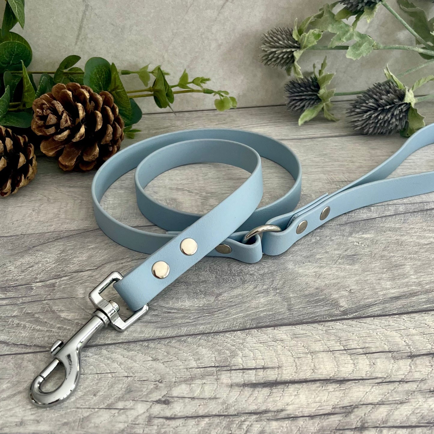 Pastel Blue Biothane lead with Silver hardware. An O-ring connects the handle to the lead with double ended rivets fixing it together. A Snap Clip is fixed with double ended rivets. The lead has a soft leather appearance.