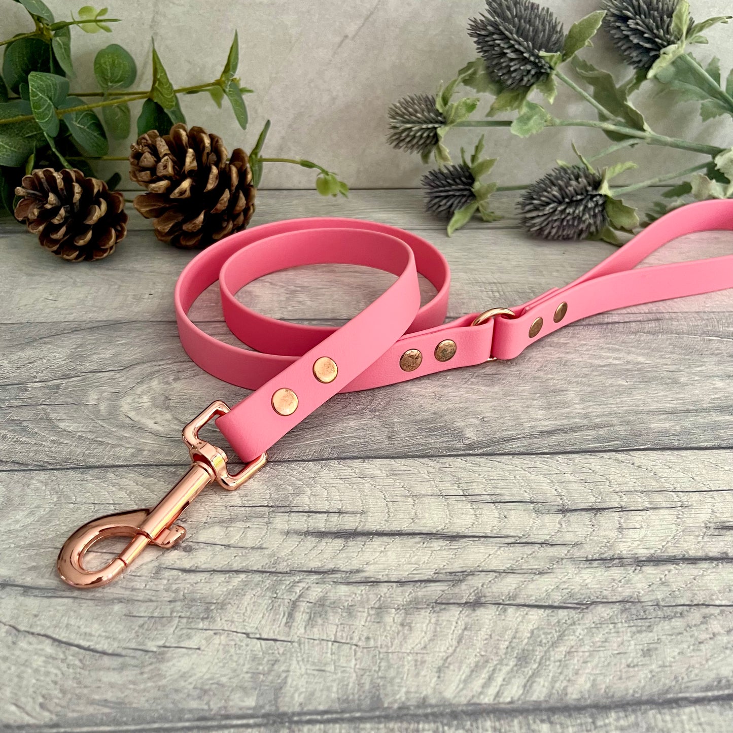 Pink Biothane lead with Rose Gold hardware. An O-ring connects the handle to the lead with double ended rivets fixing it together. A Snap Clip is fixed with double ended rivets. The lead has a soft leather appearance.