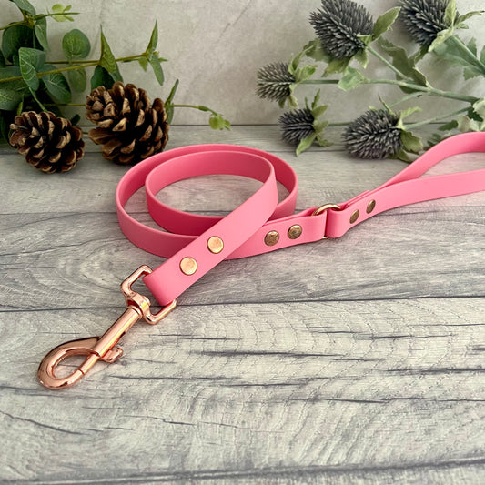 Pink Biothane lead with Rose Gold hardware. An O-ring connects the handle to the lead with double ended rivets fixing it together. A Snap Clip is fixed with double ended rivets. The lead has a soft leather appearance.