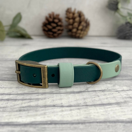 Two tone dog collar in Sage and Dark green. The collar strap is two colous fixed together with a rivet. The collar has a Biothane strap keeper and a metal D-ring with 5 x punched holes. All hardware is Antique Brass