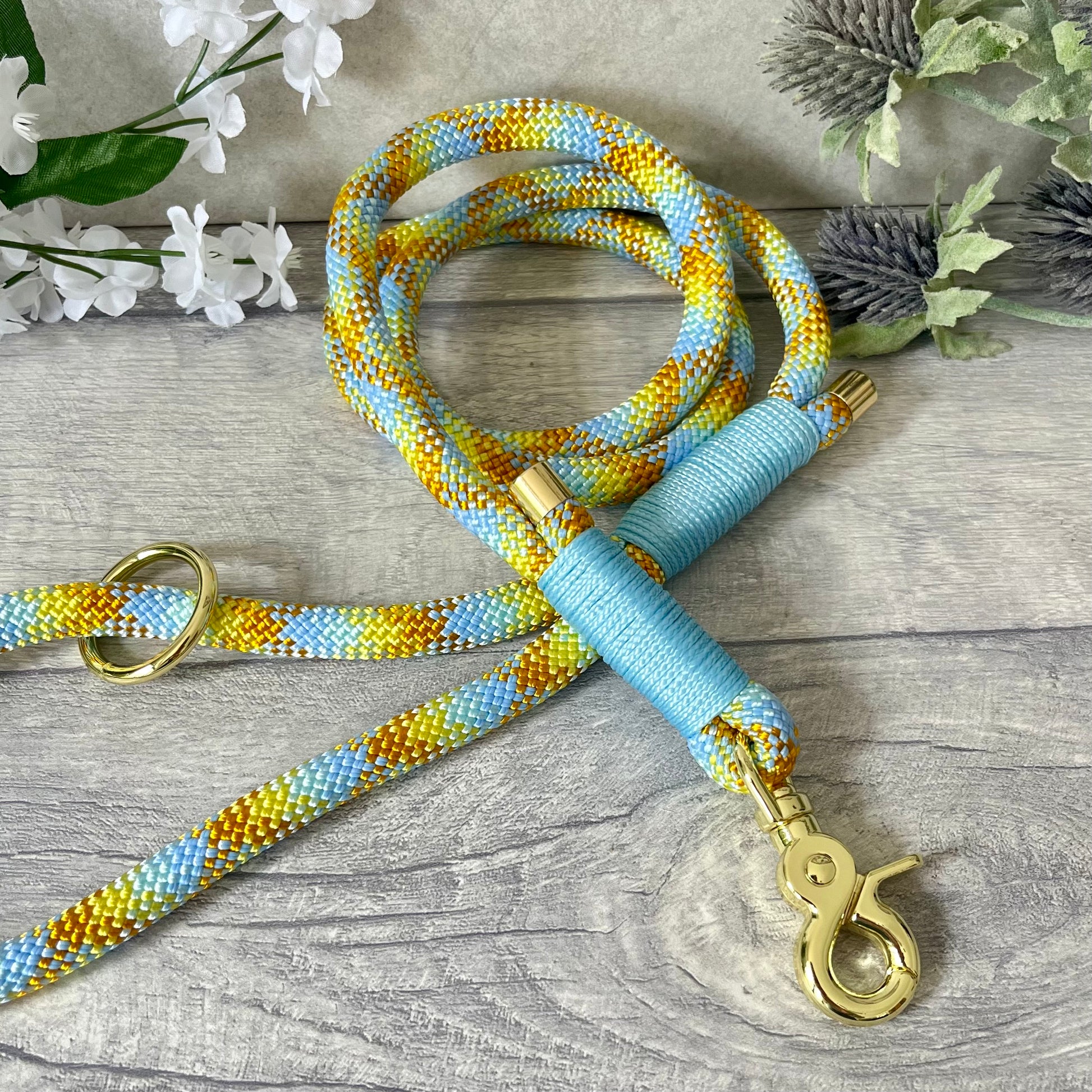 Miami Mix, Yellow rope lead with Baby Blue whipping securing a swivel clip at one end and fastening a handle at the other. The handle has an O-ring attached. Each end of the rope is finished with a metal end cap. All hardware for this lead is in Gold