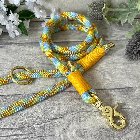Miami Mix, Yellow rope lead with Honey whipping securing a swivel clip at one end and fastening a handle at the other. The handle has an O-ring attached. Each end of the rope is finished with a metal end cap. All hardware for this lead is in Gold
