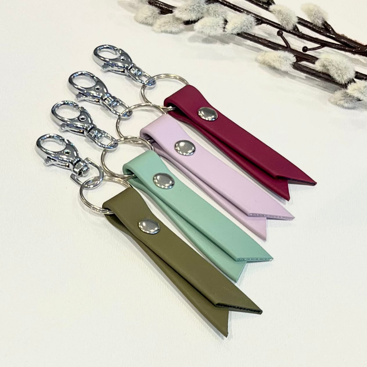 biothane keyrings with colourful straps sitting on a white surface