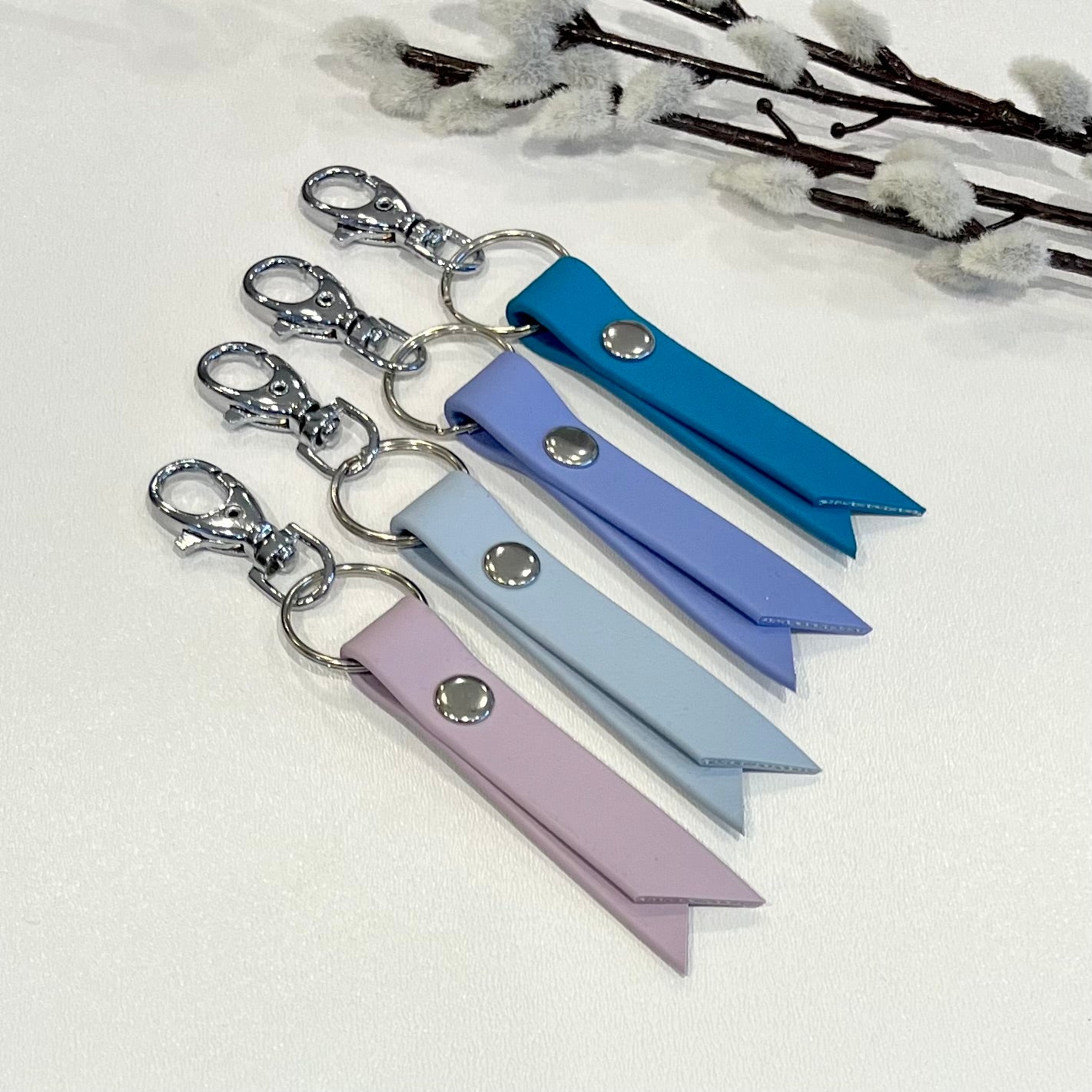biothane keyrings with colourful straps sitting on a white surface