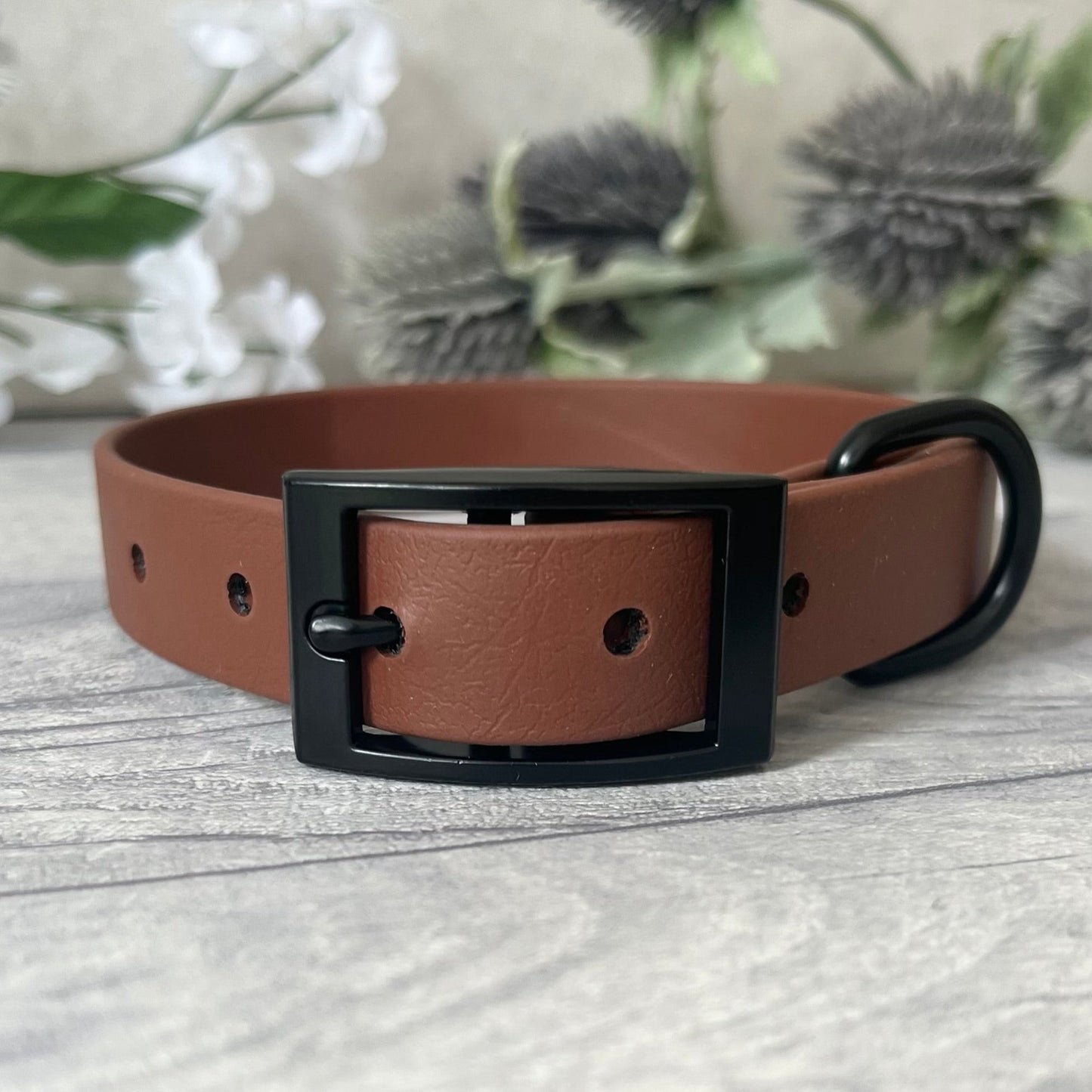 Biothane custom collar in Brown with Antique Brass buckle and a D-ring. The collar has 5 holes which are spaced 2cm apart. The collar is fastened on the first hole and has a soft leather appearance