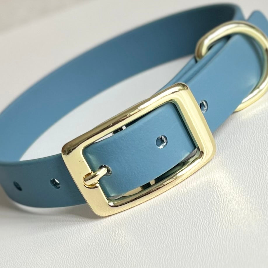 Blue biothane dog collar with a gold buckle