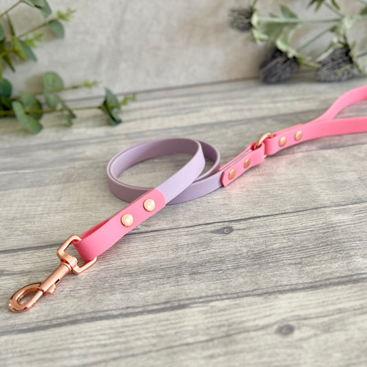 Two coloured Biothane dog lead. The handle and accent colour at the clip end of the lead is Pink, the mail lead colour is Lavender giving the lead a two tone look. The hardware is Rose Gold