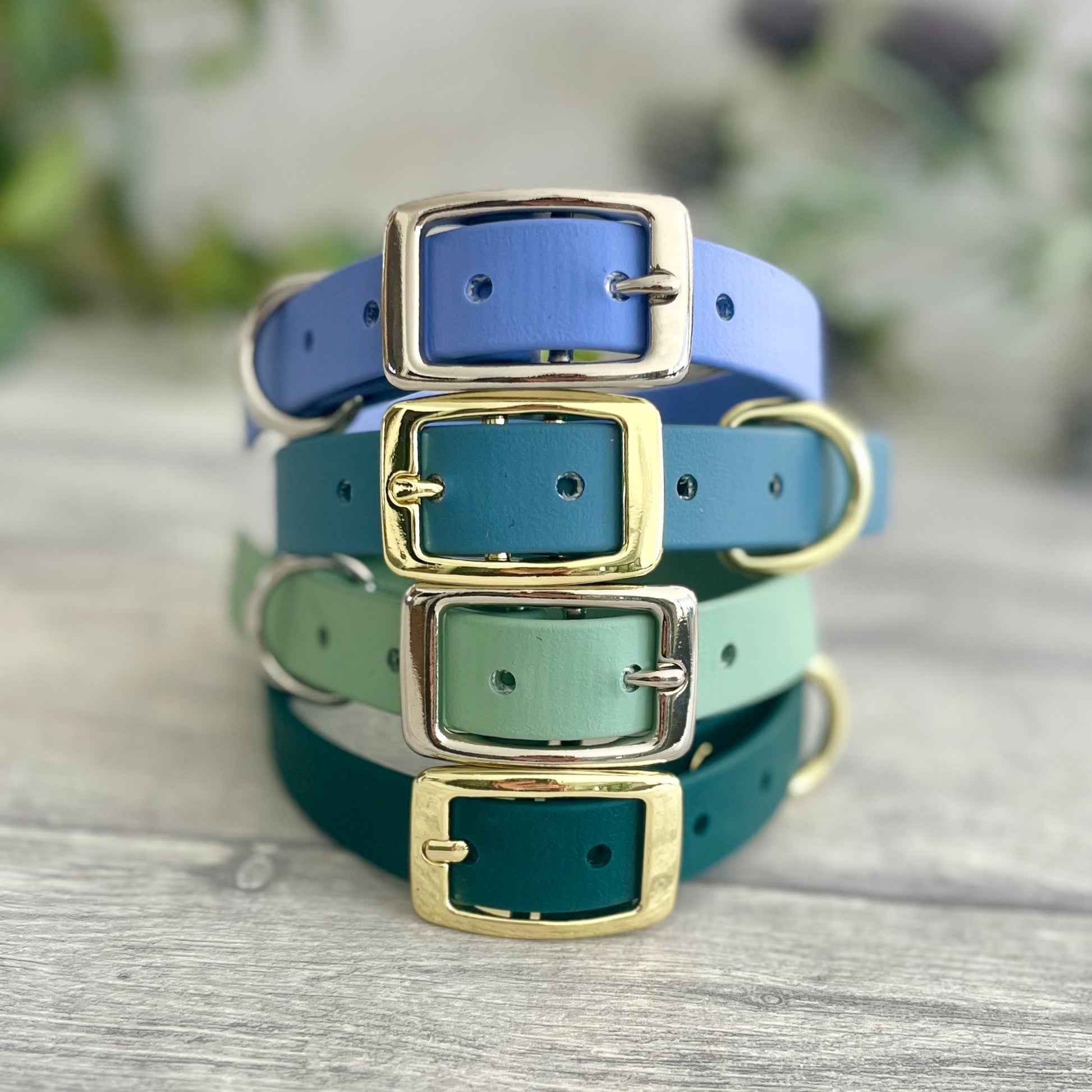 A collection of Biothane collars stacked on top of each other in a selection of colour choices. Shown in different colours of biothane and hardware, for you to design your own. All with a buckle, D-Ring. They have a soft leather appearance.