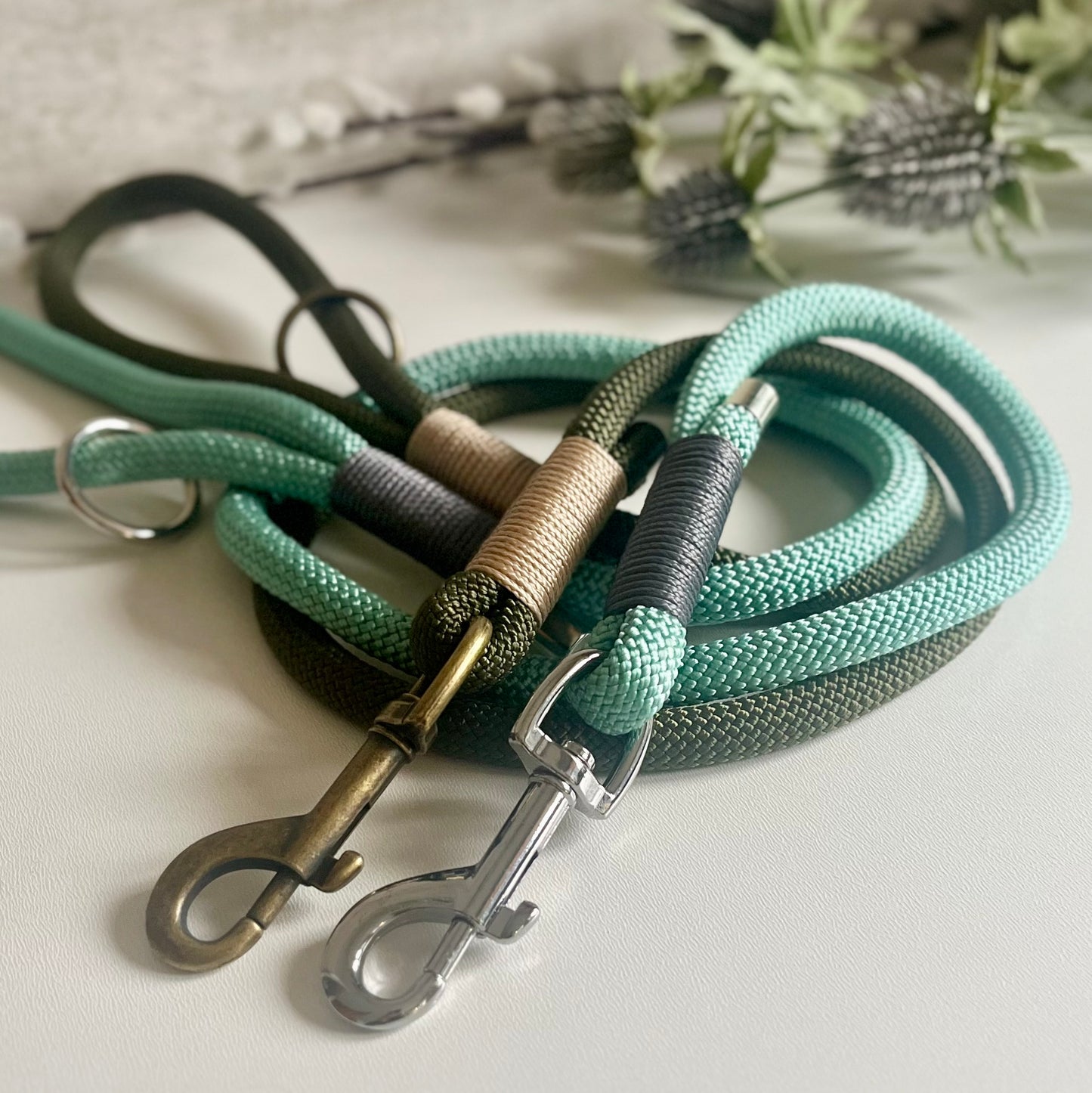 two green rope dog leads with silver and antique brass hardware 