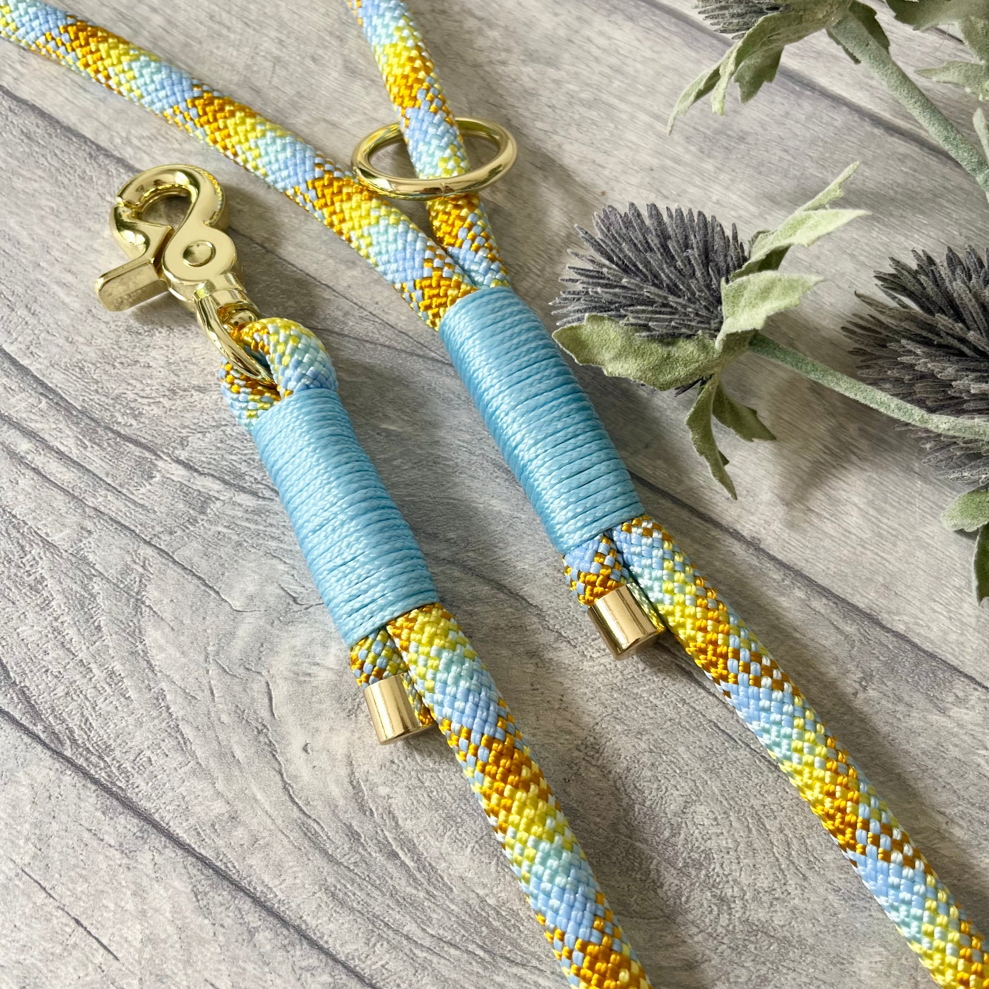 Miami Mix, Yellow rope lead with Baby Blue whipping securing a swivel clip at one end and fastening a handle at the other. The handle has an O-ring attached. Each end of the rope is finished with a metal end cap. All hardware for this lead is in Gold